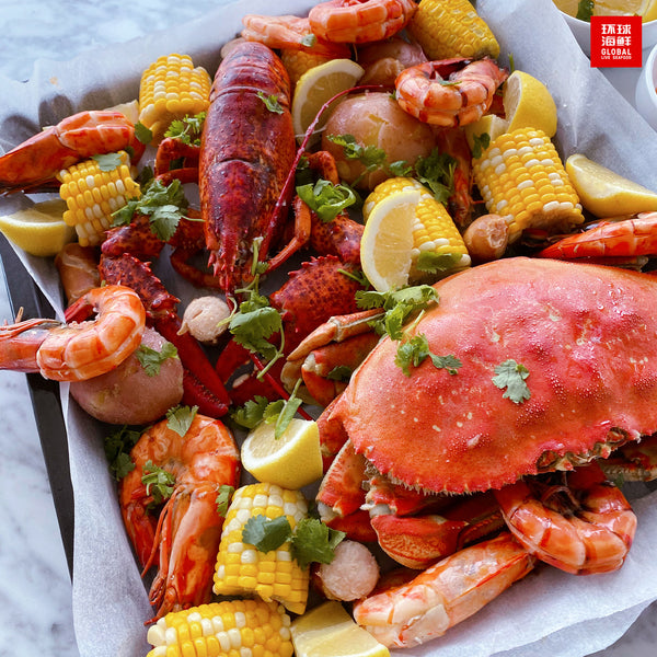 cooked seafood boil with live dungeness crab and live boston lobster